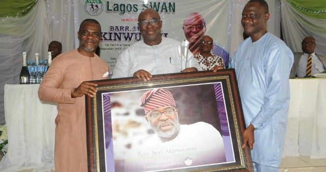 Barrister Seyi Akinwunmi being presented with a giant photo frame at the event...