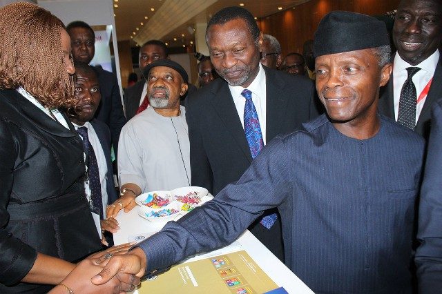 Vice President Yemi Osinbajo, right, with others at the stand of Stanbic IBTC...