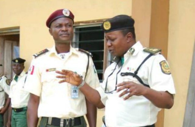 Bamgboye Okanlawon, left, with another officer during a recent event...