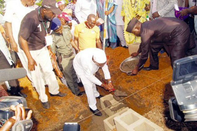 Aregbesola laying the foundation stone of the estate…with him is Arc Muyiwa Ige (left)