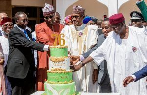 Buhari @ 76: See Images Of How Aides Surprised Him President Muhammadu Buhari...being assisted to cut his birthday cake by aides...