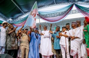 Buhari, Tinubu, Others Storm Uyo, Vow To Prevent PDP’s Return To Power President Muhammadu Buhari receives the flag of APC...at the rally...