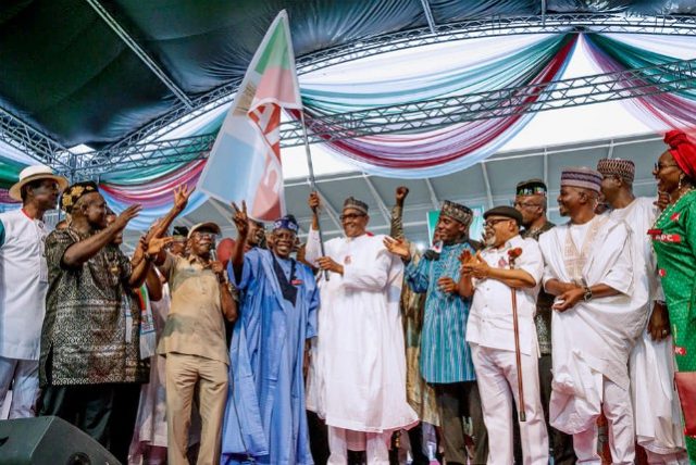 President Muhammadu Buhari receives the flag of APC...at the rally...