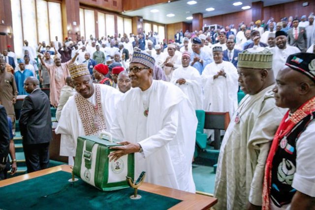 President Muhammadu Buhari, middle, with the budget in the National Assembly on Wednesday...