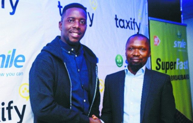Uche Okafor – Country Manager, W/Africa at TaxifyNigeria in a handshake with Gbolahan Thomas – Head, Legal & Corporate Services at Smile Nigeria signposting the partnership between Smile and Taxifyto to boost Driver and Rider Trip Experiences with 4G LTE Mobile Connectivity…