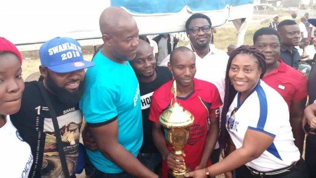 Folarin Familusi and wife presenting trophy to the winners of 2018 SWANLUX Soccer Tourney