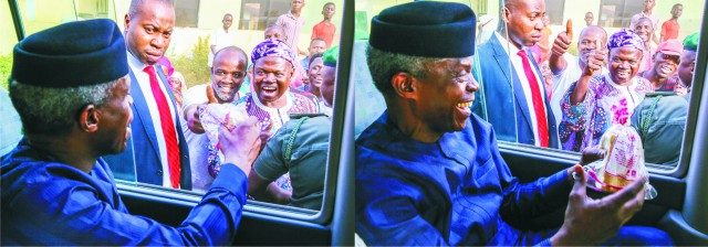 ...Vice President Yemi Osinbajo being given a loaf of bread by enthusiastic Abuja resident...