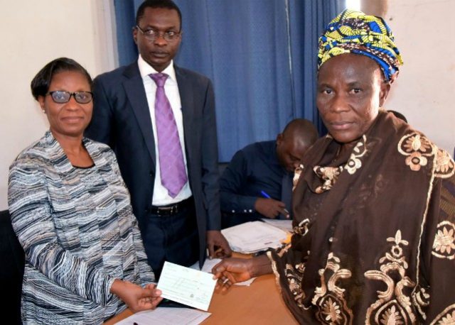 L-R: Acting Permanent Secretary, Office of the Head of Service, Mrs Adejoke Eyitayo, Director Pension and Post Service, Mr Adekunle Adesola while presenting a cheque to one of the beneficiaries, Mrs Kobiowu Simbiat at the Old Ministry of Establishment and Training, Secretariat, Ibadan on Thursday…
