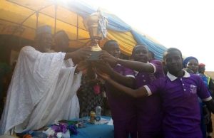 Cleric To Governments: Apply Principles Of Child Rearing To Bring Best Out Of Children Professor Olagoke Ariyo presenting a trophy to the representatives of Purple House at the event..