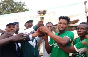 How Shafaudeen Patriots Won The 14th Edition Of Rasool Under 18 Football Competition Prof. Ariyo Olagoke being assisted by Dr. Bashir Olanrewaju to present the trophy to the Captain, Shafaudeen Patriots