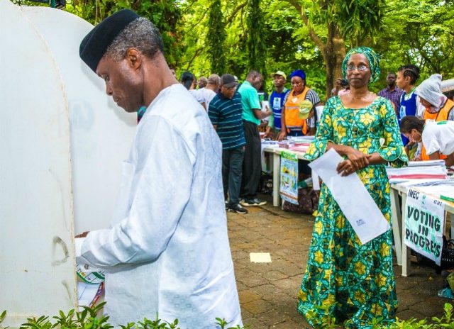 Vice President Yemi Osinbajo casts his vote...while his wife, Dolapo looks on...