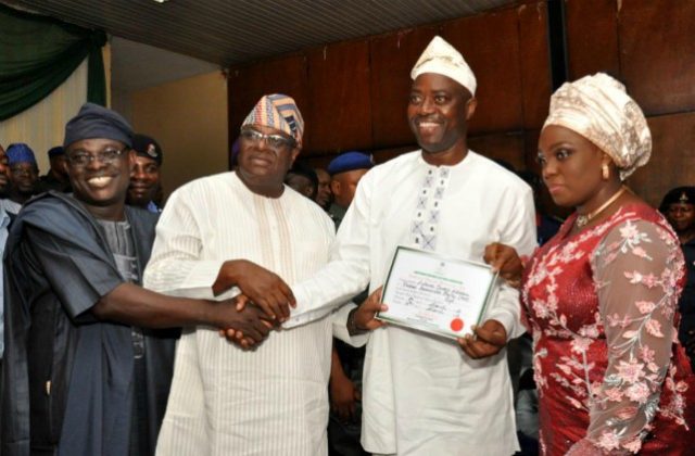 L-R: Oyo Resident Electoral Commissioner, Barr Mutiu Agboke, INEC National chairman in charge Oyo, Osun and Ekiti, Chief Solomon Adedeji presenting certificate of return to Oyo State’s Governor-elect, Engr Seyi Makinde while his wife Omini looks on…