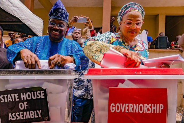 L-R: Oyo State Governor, Senator Abiola Ajimobi; and his wife, Florence, casting their votes at Ward 11, Unit 20, Oluyole Community Grammar School, Oluyole, Ibadan... on Saturday