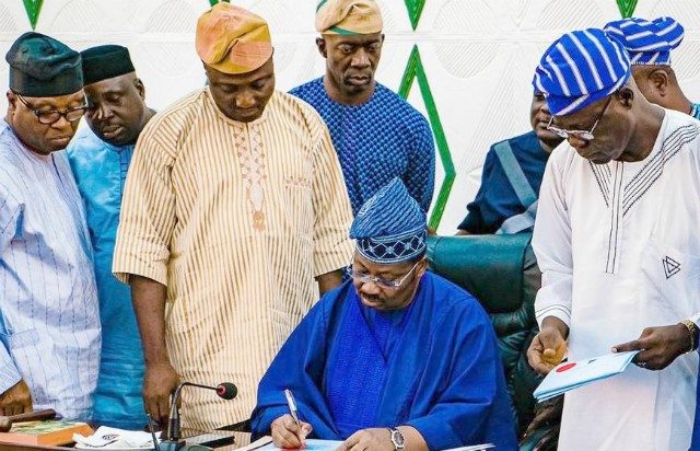 L-R: Secretary to Oyo State Government, Mr Olalekan Alli; Special Adviser on Efficiency to the governor, Dr Isaac Ayandele; Majority Leader of the House of Assembly, Hon. Kehinde Subair; Commissioner for Finance, Mr Bimbo Adekanmbi, state Governor, Senator Abiola Ajimobi; and Speaker of the House of Assembly, Rt. Hon. Olagunju Ojo, during the signing ceremony…