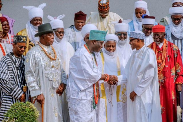 ...President Muhammadu Buhari in a warm handshake with the Ooni of Ife, Oba Adeyeye Ogunwusi...while other monarchs look on...