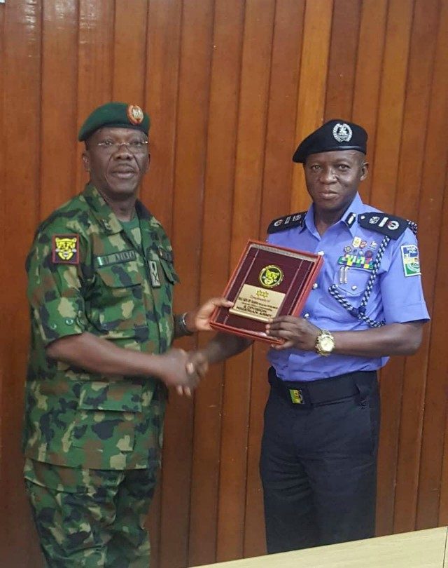 ...Major-General F.O. Azinta, left, with AIG Leye Oyebade...during the visit...
