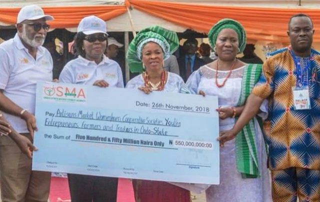 Governor Oluwarotimi Akeredolu, left, wife, Betty, and others during the cheque presentation...