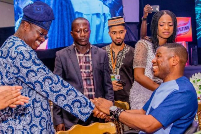 Governor Abiola Ajimobi, left, exchanging greetings with Dr Yinka Ayefele at the event...