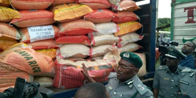 Nigerian Custom Service officers...with some of the seized goods...