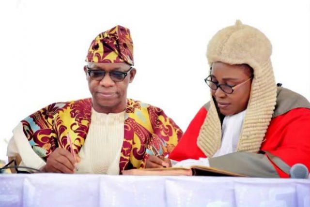 Governor Dapo Abiodun, left, signing to 'resume duties' as the Governor of Ogun State...on Wednesday...