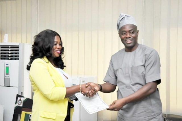 Engr Seyi Makinde (right) presenting the Certificate of Occupancy to the Sales representative of the Nigeria National Petroleum Cooperation (NNPC) Retail Limited in Oyo State, Mrs Toluwase Adesanya…on Monday…