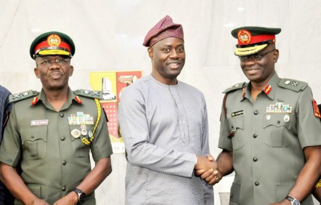 Seyi Makinde Oyo State Governor, Mr Seyi Makinde (middle) in handshake with the new General Official Commanding 2 Division, Nigeria Army, Major General Anthony Omozoje (right) while the outgoing GOC, Major General Okwudili Azinta looks on…