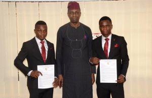 EKSU Honours Outstanding NYSC Members Prof. Edward Olanipekun, middle, with the two corps members...