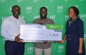 Heritage Bank Rewards Local Content Language For October 1st “National Pledge” Rendition L-R- Victor Amakwe, Group Head, Private Wealth Management; Idowu Peace Ilesanmi, winner in the social media challenge of recitation of National Pledge in Pidgin English; and Cynthia Ndukuba, Head, Head Office Compliance Assurance, Compliance and Transaction Assurance during N1million cheque presentations to four winners of the videos recitation of “National Pledge” in Pidgin English, in celebration of Nigeria @ 60th at the bank’s head office