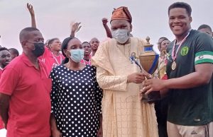 When OAU Hosted Wale Okediran Football Tourney’s 35th Edition …the VC OAU Ile Ife, Prof Tope Ogunbodede presenting the trophy to the Captain of the winning team, Paul Igbokwe, while Dr Wale Okediran and wife watch…