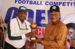 Ekiti To Host Demola Popoola Inter LG Football Tourney ...Otunba Ademola Popoola (left) presenting the trophy to the Chairman main organizing committee for the tourney, Otunba Femi Arowosola (right) during the unveiling of the tournament…