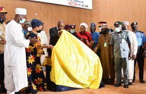 NIPOST’s N50 Revenue Stamp Launched By Buhari’s Govt …the Minister of Communications and Digital Economy, the special guest of the event, unveiling the Revenue Stamp while other Dignitaries watched…