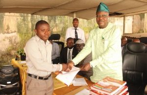 Over 16,500 Public Primary School Teachers Promoted By Makinde’s Govt ...Dr. Nureni Adeniran, right, presenting letter to a teacher...
