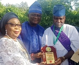 ...Iyaloja of Ibadan, Chief Mrs Abiola Iswat Ameringun, left, presenting an award to Engineer Sunday Gbenjo, right...