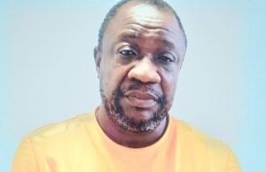 Two Suspected Currency Counterfeiters With Fake $270,000 Nabbed By EFCC In Abuja ...Johnson Olumoyegun...one of the suspects with his fake dollars and fake ID...