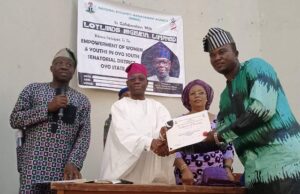 Over 390 Constituents Trained, Empowered By Senator Balogun Senator Kola Balogun, in white agbada, gives out a certificate to one of the recipients...
