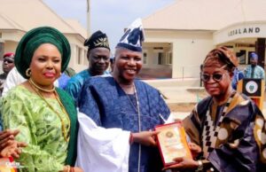 Read About 10 Giant Strides Of Yinka Fasuyi As First Asiwaju Of Ijesaland @ 7 …then Governor of Osun State, Adegboyega Oyetola on the right presenting a plague in recognition of sterling leadership in the construction of Ijesaland Geriatric Centre to the Centre's initiator, Asiwaju Yinka Fasuyi during the commissioning of the Centre on Thursday 31st March 2022. Watching is the Yeye Asiwaju of Ijesaland Dr Olubisi Fasuyi…