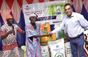 Farmers In Host Communities Receive Agricultural Inputs From Dangote Cement L–R: Ademola Ojolowo, Head of Social Performance, Dangote Cement Plc, Ibese plant; Elder Simon Oyewole, One of the farmer beneficiaries and Roy Uttam, Plant Director, Dangote Cement Plc Ibese plant, congratulating the beneficiary during the Agric Inputs presentation at Dangote Cement Plc Ibese plant, at the 2024 Farmers Empowerment Programme held at Ibese, Ogun state...