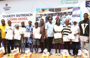Dangote Cement Commits To Carbon Emission Reduction For Business Optimisation …Beneficiaries of the Dangote Cement Sustainability Team displaying their Skills acquisition scholarship certificates at the Ajomo-Ikosi community in Kosofe Local Government during the 2024 Sustainability Week celebrations in Lagos…
