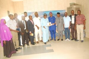 Ambassador Olayinka Agboola and others after the cutting of the anniversary cake