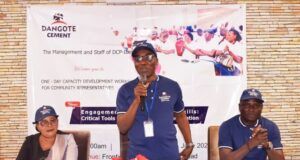 Optimal Performance: Dangote Cement Ibese Trains Host Community Leaders …Mr. Aina Olugbenga, GM HAM/Admin, Dangote Cement Plc. Ibese (standing) delivering his opening remarks while Mrs. Olalode Akiode, representative of Yewa North Local Government (left), Mr. Ademola Ojolowo, Head, Social Performance, Dangote Cement Ibese Plant (right), listen at the Capacity Building Workshop for Host Community Representatives held at Ibese, Ogun State…
