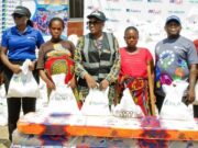 Team Lead, CSR, Fidelity Bank Plc, Victoria Abuka (left); CEO, The Abbasid Charity Foundation, Hauwa Abbas (Centre); and Branch Leader, Fidelity Bank Plc, Makurdi, Terwase (Right), representing the Regional Bank Head, North Central, Sadi Zawiya, with some beneficiaries during the Fidelity Food Bank distribution event in Makurdi, Benue State recently...