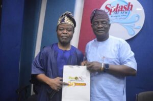 Professor Matthew Amusanreceiving ParrotXtra Media Network's 20th Anniversary package from Ambassador Olayinka Agboola after the Radio Show...