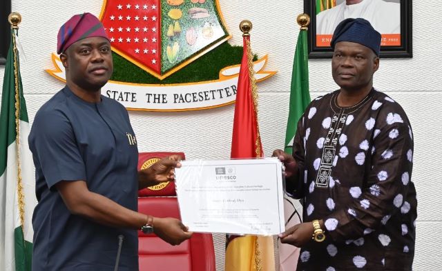 Seyi Makinde and Wasiu Olatubosun Oyo State governor, ‘Seyi Makinde (left); receiving the UNESCO Intangible Cultural Heritage Certificate for Sango Festival from Commissioner for Culture and Tourism, Dr Wasiu Olatubosun, during the State’s Executive Council meeting, held at Executive Chamber, Governor's Office, Secretariat, Ibadan…