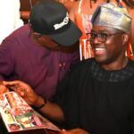 Oyos Governor Seyi Makinde holding our ParrotXtra Magazine with our Publisher Ambassador Olayinka Agboola left at Fasola Oyo on Thursday December 25 2025
