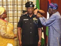 High Expectations As Tinubu Decorates Tunji Disu As Acting IGP Acting IGP, Tunji Disu, being decorated by President Bola Tinubu, while the police officer's wife watches...