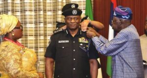 High Expectations As Tinubu Decorates Tunji Disu As Acting IGP Acting IGP, Tunji Disu, being decorated by President Bola Tinubu, while the police officer's wife watches...
