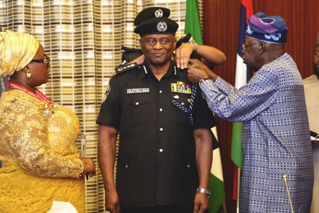Disu Acting IGP, Tunji Disu, being decorated by President Bola Tinubu, while the police officer's wife watches...