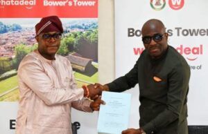 Makinde’s Govt Reveals Plans To Redevelop Historic Bower’s Tower Two men shake hands while exchanging a blue document at a corporate event, with Bower's Tower banners in the background.