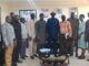 Oyo Govt, FERMA Strengthen Collaboration On Road Maintenance Group of professionals posing for a photo in a conference room, some holding folders, a glass coffee table in front.