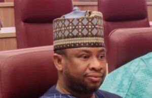 Nigeria’s Ambassador-Designate To Algeria, Mohammed Lele, Dies At 50 Smiling man in a traditional patterned cap and dark blue agbada seated in a conference room.